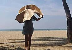 Huge-titted woman flashes her hairy pussy and small tits on a public beach.