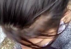 Brunette babe gives blowjob in public street