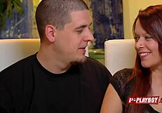 In the dimly lit room, a redhead couple engages in interracial passion as she receives oral pleasure on her pussy while performing fellatio on her black partner.