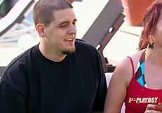 In the dimly lit room, a redhead couple engages in interracial passion as she receives oral pleasure on her pussy while performing fellatio on her black partner.