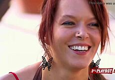 In the dimly lit room, a redhead couple engages in interracial passion as she receives oral pleasure on her pussy while performing fellatio on her black partner.