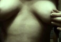 Natale massages her natural tits on show.