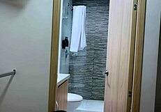 Camera captures two latina friends kissing outdoors at airbnb