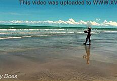 Wife strips nude for football on public clothed beach.