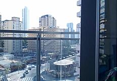 A hot gamer girl in clothes flashes her big tits on the balcony outdoors