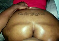 Ebony woman with big oiled ass in black setting