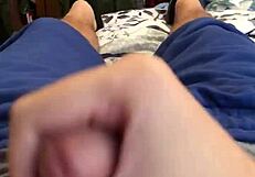 Male jerks off intensely on bed, losing NNN challenge with big cumshot.