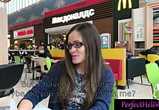 A young brunette woman engages in public interactions with strangers at the resort, leading to an unexpected encounter