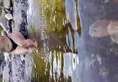 Brunette latina exhibitionist bathes in river with natural tits exposed and touches nipples