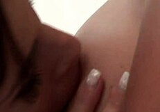 Intense lesbian passion ignites on business trip with shaved brunette fingering and licking in ripped clothes on bed