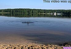 Young woman goes naked at a public beach and gets wet in the sea