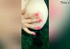 a young 18+ beauty in green dress plays with her big natural tits