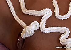 Busty milf fingers her pierced pussy with whipped cream