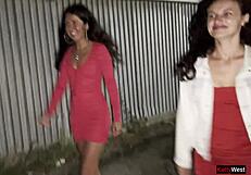 OMG, two girlfriends peeing together by a car in public lot, so daring!