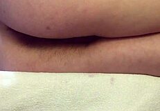 Close-up of hairy pussy as she masturbates to orgasm