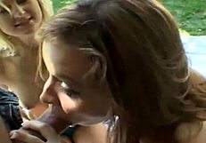 Two beautiful women giving oral sex to a man