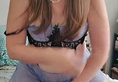 Brunette transsexual in crossdressing attire rides a pillow solo in detailed scene