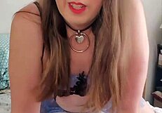 Brunette transsexual in crossdressing attire rides a pillow solo in detailed scene