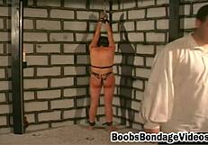 Why is this busty brunette babe tied up with squeezed boobs?