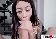 Cute inked brunette handles a massive cock with sloppy saliva