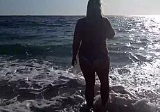 A mature and sensual woman pleasuring herself on the beach feeling aroused by the outdoors