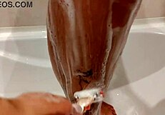 emma's tight shaved pussy gets wet in shower groping close-up.