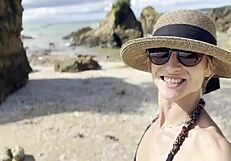 Pretty Babe Cleans Natural Beach at Pacific Ocean.