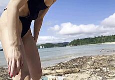 Pretty Babe Cleans Natural Beach at Pacific Ocean.