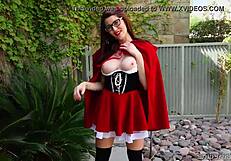 Amber Hahn in little red costume plays solo outdoors