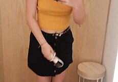 Man jerking off in the shop's changing room while trying on clothes