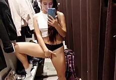 Tanned girl gets off with risky public fitting room play