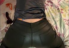 French amateur in leather pants and satin lingerie teases with heels and thong in POV