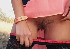 lingerie-clad babe on outdoor adventure with cream tube and peeing in nature