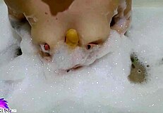 i love watching this cute babe suck that huge dildo in the bath