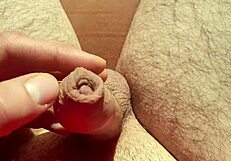 edging flaccid cock with precum in natural light