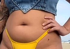 African woman flashes and arouses guy on beach.