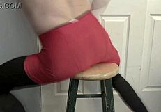 Skinny girl grinding ass on stool in black tights and red shorts, fetish style
