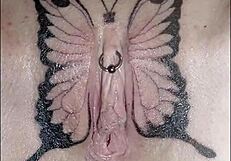 Crystal butterfly with tattoos performs music