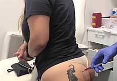 Blonde client with butt tattoo receives injection during spa massage session 2, watched voyeuristically