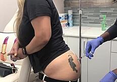 Blonde client with butt tattoo receives injection during spa massage session 2, watched voyeuristically
