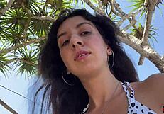 Brunette enjoys outdoor sex and a messy facial on the beach