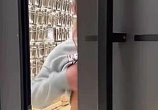 Busty babe flashes her tits all over the home store