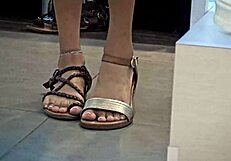 Boy accompanies his girlfriend shopping for shoes