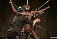 Blonde and ebony in the power of a metal device