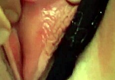 Titty slut fingers her tight pussy using a dildo while watching porn.