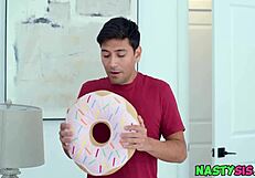 The step sister masturbates with a donut, captured in a provocative image