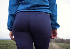 The sexy MILF with a nice ass in tight pants is viewed from behind