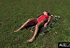Fit and slim teen gets oiled and finishes with a climax under the sun