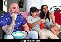 Stepmom lets the boy touch her big tits during wild family orgy.