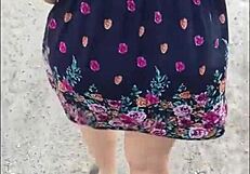 curvy mature woman walks street in skirt